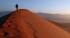 A man walking up a Sossusvlei dune