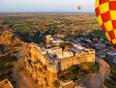 Hot air balloons flying over the temples of Jaipur