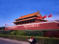 A man reading a newspaper outside the Forbidden City in Beijing