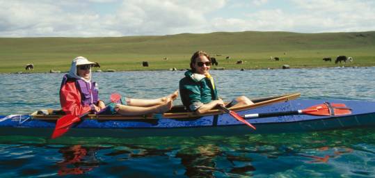Girls kayaking on a lake in Mongolia