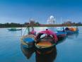 Colourful boats in front of the Taj Mahal