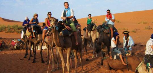 A group in Morocco setting off on a camel trek to a Bedouin camp in the Sahara
