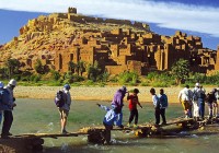 A group of people trekking near the Kasbah Ait Benhaddou