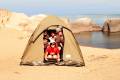 A group squeezed into a two man tent, camping on the shores of Lake Malawi