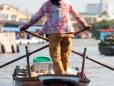 A woman rowing a boat to Can Tho floating markets 