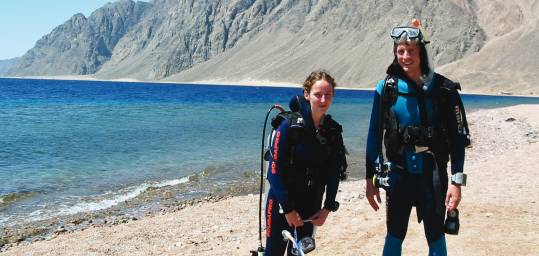 A couple of divers at the Blue Hole dive site in the Red Sea