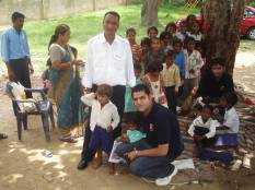 Children and an on the go guide at an orphanage in India
