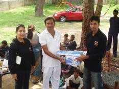 on the go staff in India donating supplies to an childrens orphanage