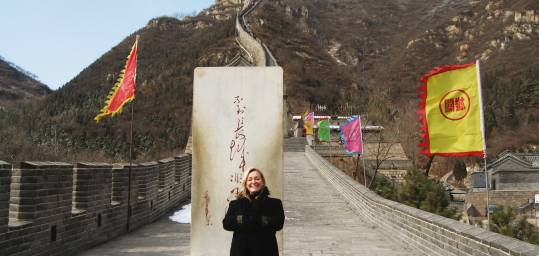 A lady stands by a monolith at the Great Wall