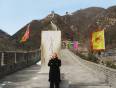 A lady stands by a monolith at the Great Wall