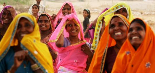 Smiling Indian ladies in bright and colourful saris