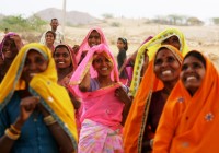 Smiling Indian ladies in bright and colourful saris