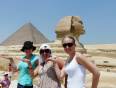 Girls striking an Egyptian pose in front of the Sphinx and pyramid on the Giza Plateau
