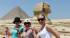 Girls striking an Egyptian pose in front of the Sphinx and pyramid on the Giza Plateau