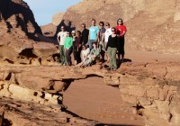A group standing on a rock formation in Jordan's red desert - Wadi Rum