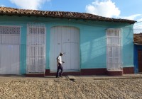 A local man walks past a colourful building in Trinidad, Cuba.
