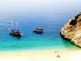 Two boats anchored where the Turquoise coast meets the sandy beach