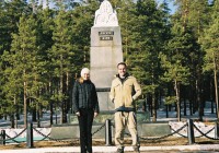 A man and woman standing at the Europe/Asia border marker in Yekaterinburg