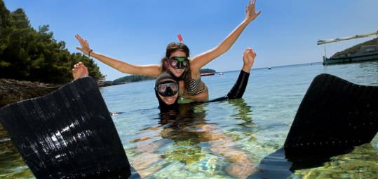 A couple in snorkel and flippers having fun in the Red Sea - Dahab