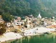 A view of Rishikesh and the Ganga river framed with lush vegetation