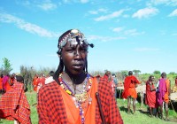 A masai man with ornate jewellery and traditional dress