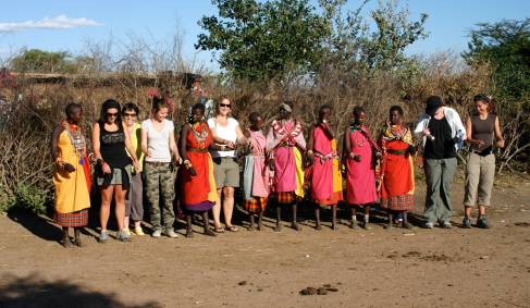 On the Go passengers learning a dance with Masai women