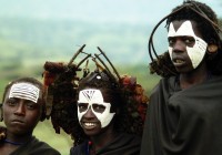 Young masai boys with their faces painted in black and white