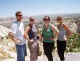 An on the go group stands in front of Cappadocia