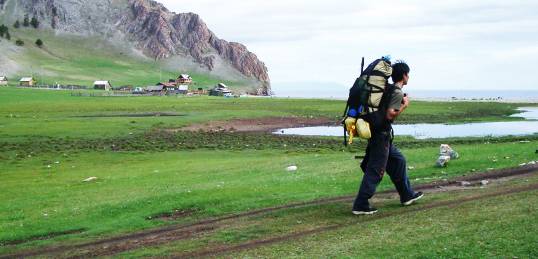 A man walking along the shores of Lake Baikal