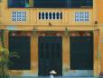 A local man in front of an ancient building in Hoi An