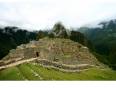 The early morning cloud dissipates to reveal stunning Machu Picchu on our Peru Tours 