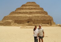 A couple standing in front of the step pyramid
