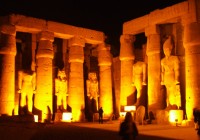 Statues of Ramses II illuminated in the Luxor temple