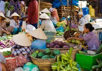 Vietnamese ladies see their wares at a floating market in Hue.