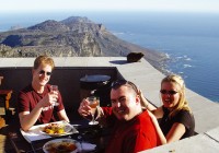 Passengers enjoy a spot of lunch with an amazing view on Table Mountain - with an unexpected guest -