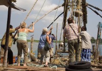 Travellers working the Chinese fishing nets in Fort Kochi