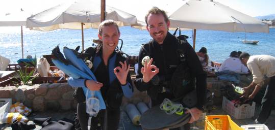 Two divers with their equipment ready to take the plunge