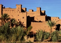 Ait Benhaddou, a Kasbah in Morocco, surrounded by lush palm trees