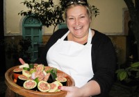 A lady with her tagine of stuffed vegetables ready to put in the oven