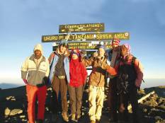 A happy group of trekkers, at the summit of Mt Kilimanjaro in Tanzania