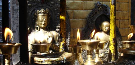 Candles and golden Buddha statues in the Golden Temple, Kathmandu