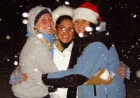 Three happy girls hugging in the snow