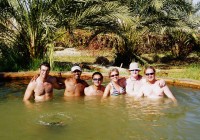 An on the go tours group relaxing in Bir Wahed hot springs in Siwa