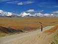 A nomad walks along a barren path throught the beautiful Lalung pass in Tibet