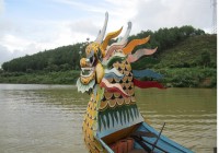 A firey dragon as the head of a boat on the Perfume River.