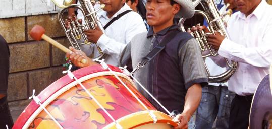 A marching band play in a street parade in Sucre, Bolivia as seen on our Bolivia tours.