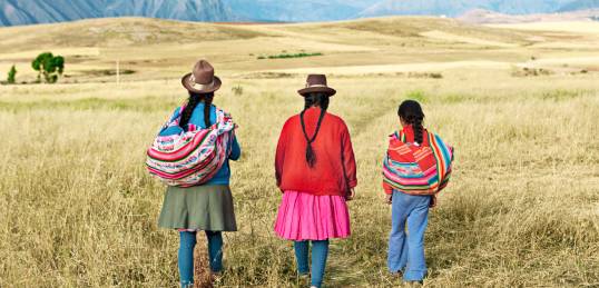 A family walking in Peru - meet the locals on our Peru Tours