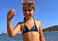 A little girl in a snorkel by the sea in Hurghada