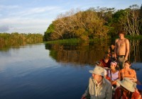 A group in a dug-out canoe, exploring the Amazon rain forest