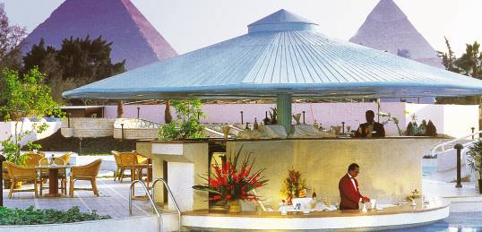 The swimming pool and pool bar, overlooking the pyramids, at the Le Meridien Pyramids hotel in Cairo